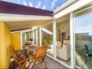 a balcony with a table and chairs and a living room at Libra Flexyrent in Rapallo