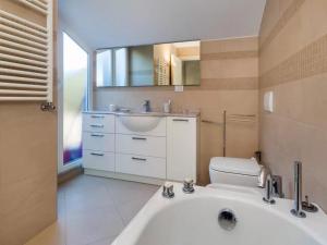 a bathroom with a tub and a sink and a toilet at Libra Flexyrent in Rapallo +59 photos