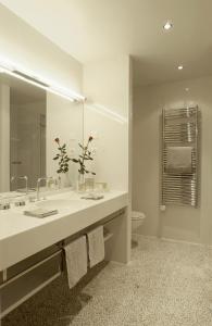 
a bathroom with a sink and a mirror at Hotel Angleterre & Résidence in Lausanne
