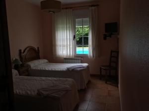 Postel nebo postele na pokoji v ubytování Os Arroxos