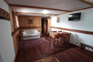 a living room with a couch and a table at Chambres D'Hotes Les Fleurs in Pila