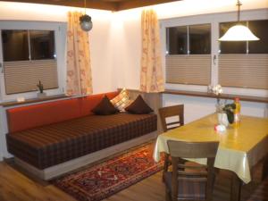 a living room with a couch and a table at Erika Sporer in Hippach