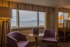 a room with two chairs and a table with a laptop on it at Seamill Hydro Hotel in Seamill