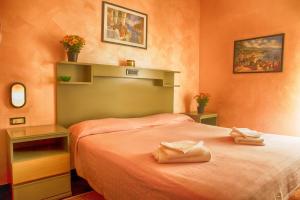 a bedroom with a bed with two towels on it at Hotel della piazzetta in Varazze