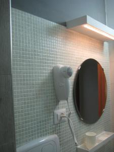 a tiled bathroom with a mirror and a sink at Residence San Antonio in Marina di Camerota +57 photos