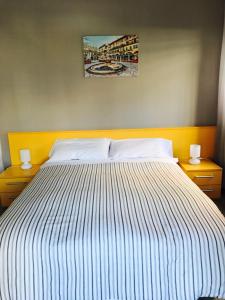 a bedroom with a large bed with two night stands at Simoni 10 in Verona