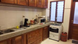 a kitchen with a sink and a stove top oven at Residence Cheikh Fall in Dakar