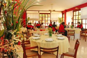 a group of people sitting at tables in a restaurant at Hotel Libertador in Santiago del Estero