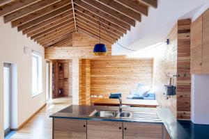 a kitchen with wooden walls and a sink in a room at Porto Pim Bay in Horta