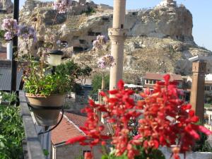 a balcony with flowers and a view of a mountain at Dar Konak Pansiyon in Urgup
