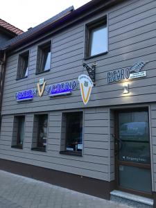 a building with signs on the side of it at Pension Victoria Halberstadt in Halberstadt