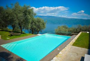 a swimming pool with a view of a lake at Cascina Varini in Gargnano