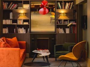 a living room with a couch and a table and chairs at Bob Hotel in Paris