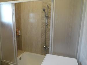a bathroom with a shower and a bath tub at Villa at Karawan Resort in Al Ḩammām +37 photos