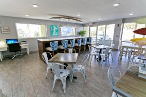 a dining room with tables, chairs, and tables at Surf & Sand Hotel in Pensacola Beach