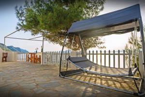 a hammock with a canopy on a patio at Seasidehouse in Hydra