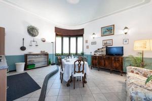 a living room with a table and a tv at Casa Bertini in Florence