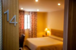 Postel nebo postele na pokoji v ubytování Hotel Cesario