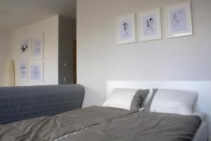 ein Schlafzimmer mit einem Bett und einige Bilder an der Wand in der Unterkunft Apartament-31 in Danzig