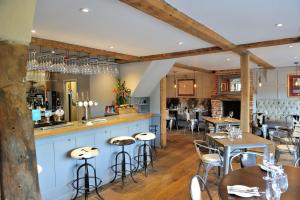 a restaurant with tables and chairs and a bar at The Dog At Wingham in Wingham