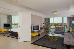 a living room filled with furniture and a tv at Warwick Paradise Island Bahamas - All Inclusive - Adults Only in Nassau