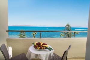a bowl of fruit on a table with a view of the ocean at Orpheus Studios in Kos Town