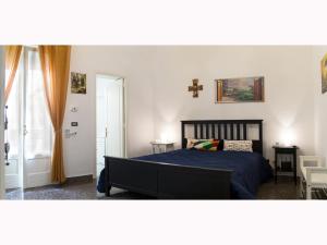 a bedroom with a bed with a blue comforter at Da zia Concetta in Campi Salentina