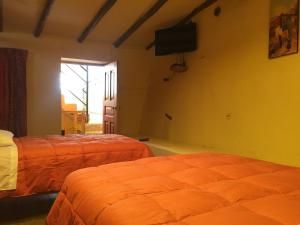 Postel nebo postele na pokoji v ubytování Rumi Sonqo Hostel