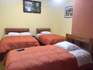 Postel nebo postele na pokoji v ubytování Rumi Sonqo Hostel