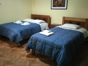 Postel nebo postele na pokoji v ubytování Rumi Sonqo Hostel