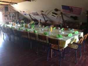a long table with chairs in a room at Idestrup Bed and Breakfast in Idestrup