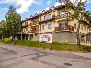 a building with a sign in front of it at Apartment Peter in Donovaly