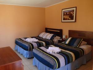 En eller flere senge i et værelse på Hostal Mirador