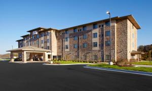 a large building with a road in front of it at Hawthorn Suites by Wyndham Wheeling at The Highlands in Triadelphia