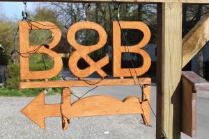 a sign that says peace hanging from a porch at Vangeled Gaard B&B - Apartments in Holtug