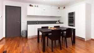 a kitchen with a black table and black chairs at Sunny Villa in Bovec