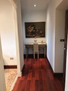 a hallway with a table and a painting on the wall at Casa Palacio VillaZambra in Ronda