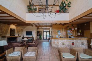 a living room with a couch and chairs at Quinta dos Poetas Nature Hotel & Apartments in Olhão