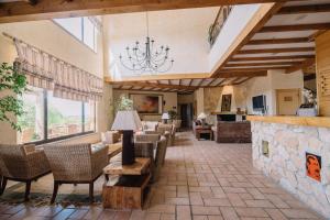 a large lobby with chairs and a chandelier at Quinta dos Poetas Nature Hotel & Apartments in Olhão
