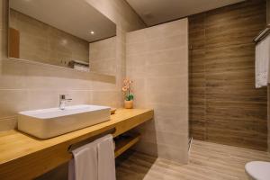 a bathroom with a sink and a mirror at Quinta dos Poetas Nature Hotel & Apartments in Olhão
