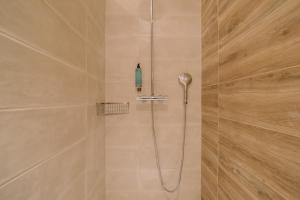 a shower with a shower head in a bathroom at Quinta dos Poetas Nature Hotel & Apartments in Olhão