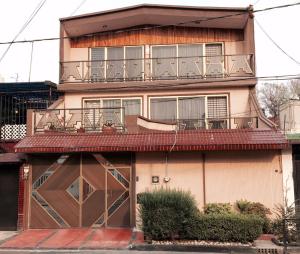 an apartment building with a balcony and a garage at Casa Q BnB in Mexico City