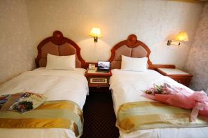 Ένα ή περισσότερα κρεβάτια σε δωμάτιο στο Wang Fu Hotel