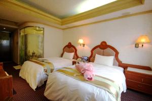 Ένα ή περισσότερα κρεβάτια σε δωμάτιο στο Wang Fu Hotel