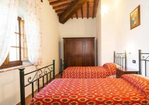 En eller flere senge i et værelse på Agriturismo Tre Madonne