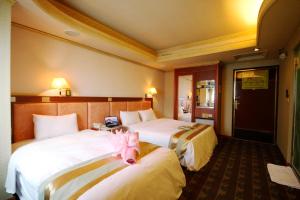 Ένα ή περισσότερα κρεβάτια σε δωμάτιο στο Wang Fu Hotel