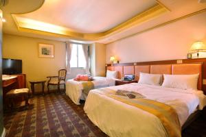 Ένα ή περισσότερα κρεβάτια σε δωμάτιο στο Wang Fu Hotel