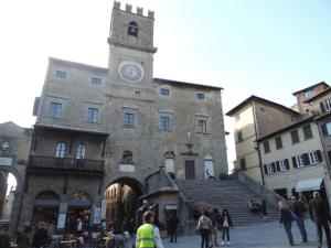 a building with a clock tower on the side of it at La Casa Dei Nonni in Cortona