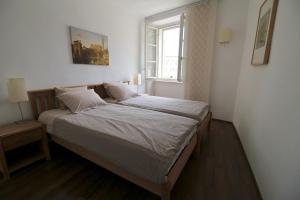 a bedroom with a bed and a window in it at Apartment Marciana in Piran
