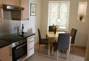 a kitchen with a table and a dining room at Apartment Marciana in Piran +16 photos